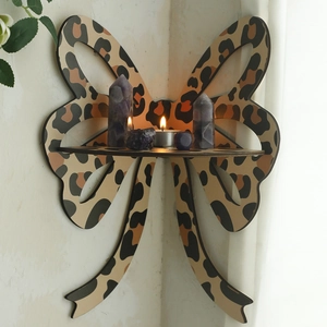 Detail of bohemian bow-shaped corner shelf with leopard print in a cozy home setting