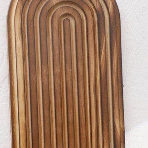 Macro shot of dark carbonized solid wood wall shelf with U-shaped grooved texture