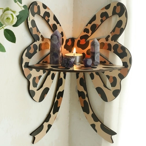 Detail of bohemian bow-shaped corner shelf with leopard print pattern on wooden surface