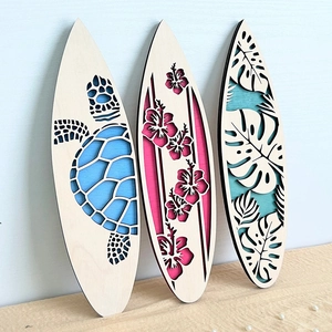 Detailed view of 3D layered wooden surfboard wall art featuring tropical turtle and leaf
