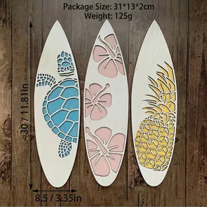 Detail of wooden surfboard wall decor set with turtle, hibiscus, and pineapple cutouts