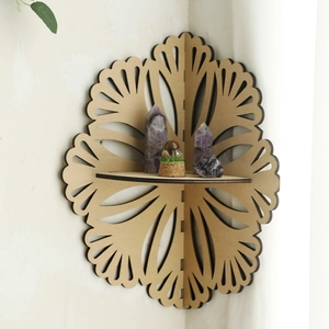 Detailed scalloped cutout patterns on a light wood corner shelf with a bohemian style