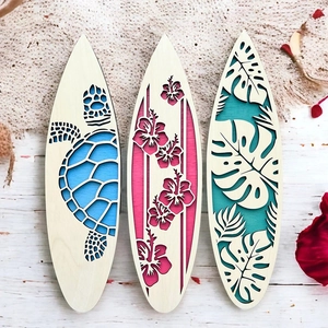 Detailed view of three surfboard wooden wall plaques with turtle and flower cutouts