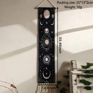 Detail of bohemian sun and moon phases tapestry with elegant black fabric and white fringe