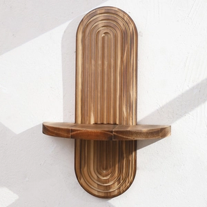 Rustic oval wooden floating shelf with carved concentric patterns for wall decor