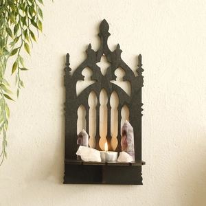 Gothic arch black wooden wall shelf featuring crystals and a scented candle detail