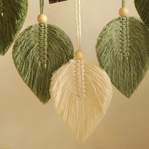 Detailed view of handmade woven leaf patterns with cotton cord and natural wood beads