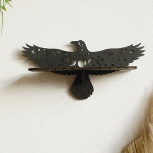 Detailed view of eagle-shaped wooden wall shelf with moon phase hollow carvings