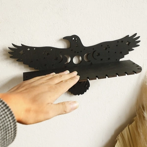 Eagle-shaped wooden wall shelf with moon phase cutouts for crystal display and home decor