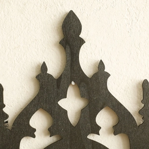 Close-up of black gothic throne shelf showing intricate carved wood textures and details