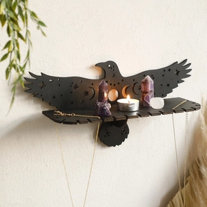 Detail of raven wooden shelf with star cutouts and necklace hanging slots