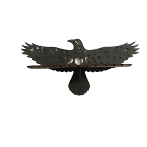 Eagle-shaped wooden wall shelf with celestial moon phase cutouts for home decor