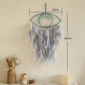 Detail showing Evil Eye dream catcher with tree of life and soft blue feathers