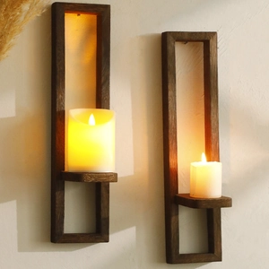 Macro detail of wall-mounted wooden candle holders with a rustic charred finish