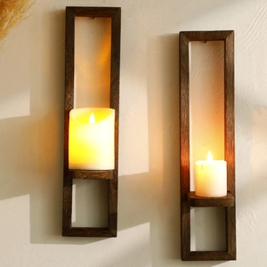 Detail view of rustic brown wood wall candle holder with white pillars and warm light