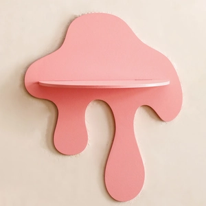 Detail of creative pink dripping fluid shelf mounted on a textured beige wall