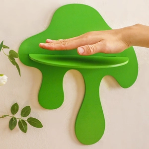 Detail view of a creative green melting drip shaped wooden wall shelf for home decor