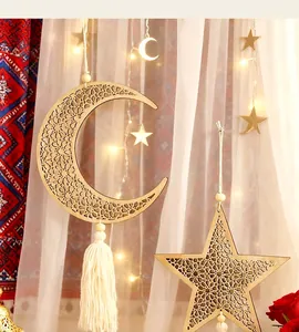 Detailed view of moon and star wooden pendants with white tassels for wall decor