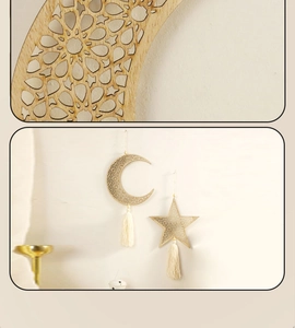 Detail of laser-cut wooden moon and star wall hanging with white bohemian tassels