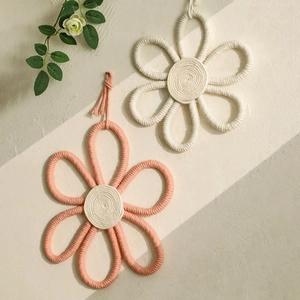 Handmade boho cotton rope flower wall decor in cream white and pastel pink tones