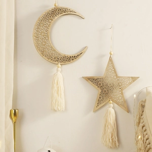 Bohemian moon and star wooden wall hanging set with intricate cutouts and cotton tassels