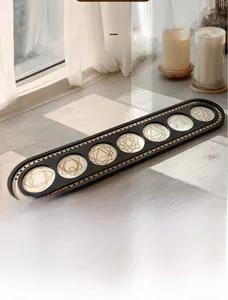 Detail of wooden display shelf with seven chakra symbols engraved in circular slots