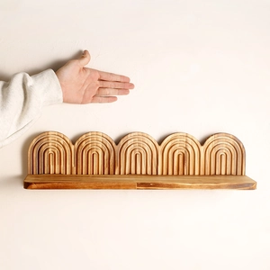 Minimalist wall-mounted wooden shelf with arched carving details for home decoration