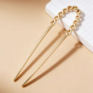 Elegant gold U-shaped hair pin with a twisted design for stylish bun hairstyles