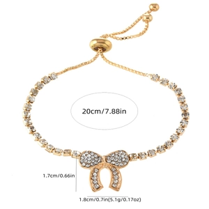 Gold bow crystal bracelet with sparkling rhinestones and adjustable sliding chain clasp
