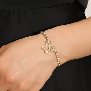 Elegant gold bow crystal bracelet with adjustable drawstring closure for women on wrist