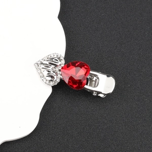 Detail of red heart gemstone hair clip with silver 'love' hollow heart and rhinestones