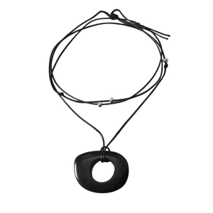 Minimalist obsidian ring pendant necklace with black cord and silver beads on white background