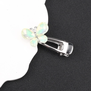 Detail of silver iridescent butterfly hair clip with crystal wings and metal duckbill grip