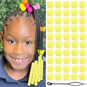 Macro view of bright yellow acrylic hair beads for dreadlocks with beading tool accessories