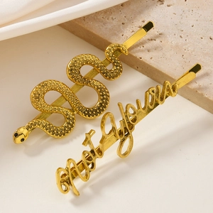 Two-piece gold snake and 'Not Yours' letter hair clip set with metallic texture