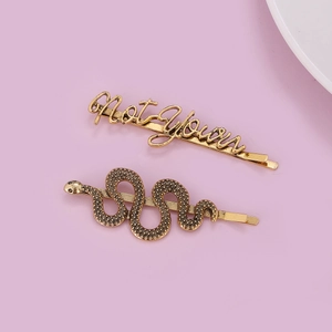 Gold-plated snake and Not Your letter hair clip set with fine metallic textures