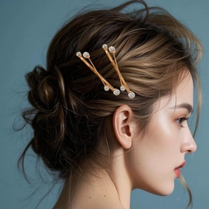 Golden hair clip set with sparkling rhinestones worn on elegant braided hair