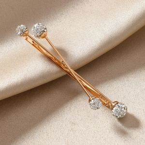Elegant gold-tone criss-cross hairpins with pearl crystal spheres on champagne satin