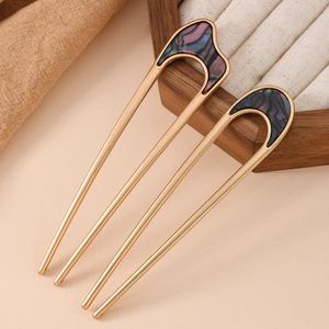 Elegant set of two U-shaped matte gold metal hair pins with blue marble pattern inserts