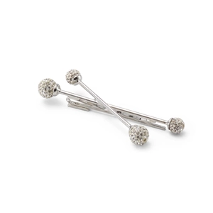 Detail of silver crossover hairpins featuring white rhinestone spherical ends on a white base