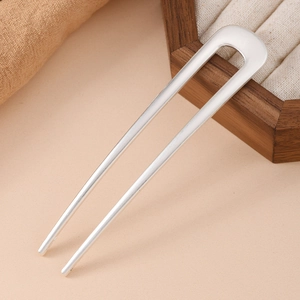 Detailed view of silver U-shaped hair pin showing minimalist sleek design and matte finish