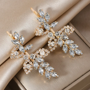 Elegant gold leaf hair clips with sparkling rhinestones for bridal wedding hairstyles