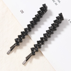 A pair of minimalist black rhinestone snap hair clips with a metal base for women