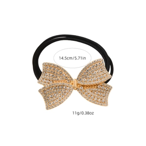 Elastic hair tie with a rhinestone-studded gold bow accessory on a plain background