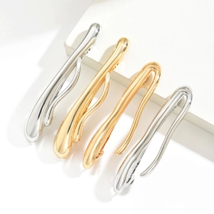 Minimalist liquid metal hair clips in gold and silver finish with sleek mirror polish