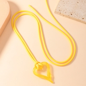 Minimalist yellow resin heart pendant necklace with matching woven tie cord strap