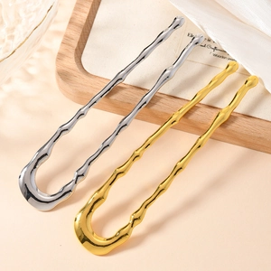 Detailed view of U-shaped metal hair pins in gold and silver with bamboo wave texture