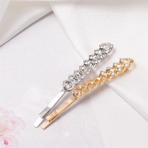 Sparkling rhinestone chain hair clip set in gold and silver finish on silk background