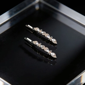 Elegant silver hair clips with floral crystal patterns in a premium gift box display