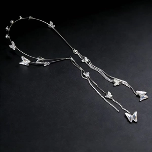 Silver butterfly tassel headband with shimmering rhinestones on a charcoal background